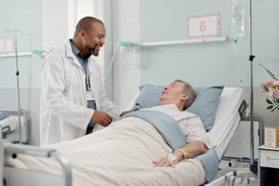 a doctor speaks with a patient in bed