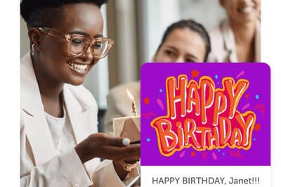 Smiling person holding cake and a happy birthday post