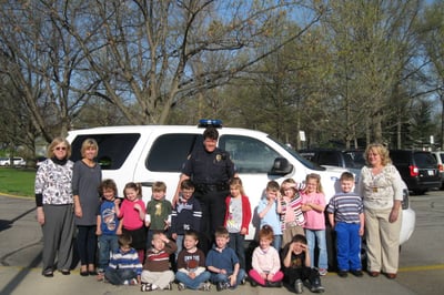 Children posing with police officer