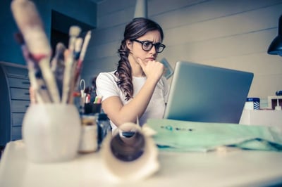 Person thinking hard while looking at laptop