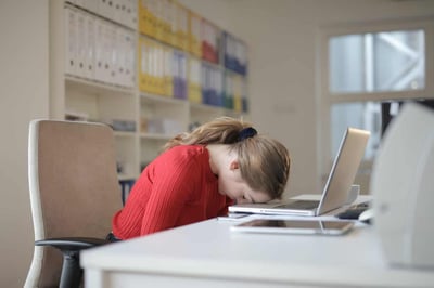 Person with head down on laptop