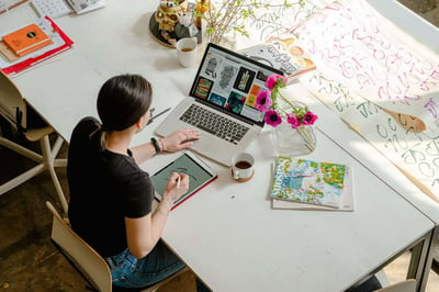 Person working on art at laptop and tablet