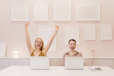 Celebrating employees in front of laptop