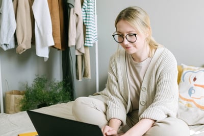 Person working on laptop in bed