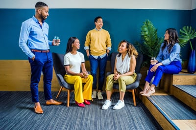 Office workers talking together in meeting room