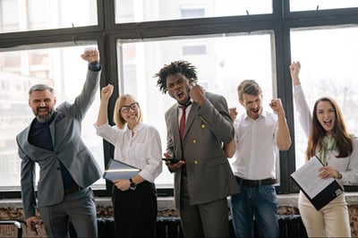 Staff celebrating in office hallway