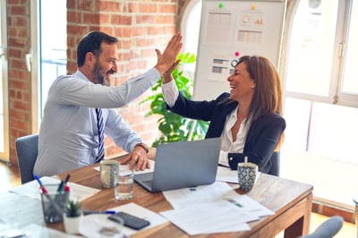 Coworkers high-fiving together