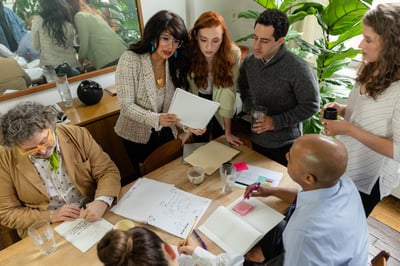 People looking at document around table