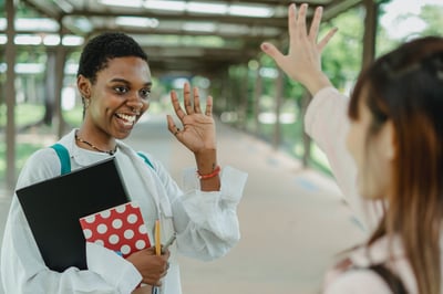 Person waving goodbye to a friend