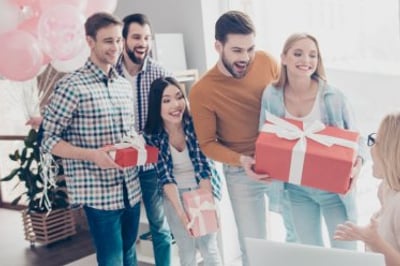 A group presenting a group gift to a coworker