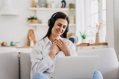 Remote employee with headphones on laptop feels appreciated