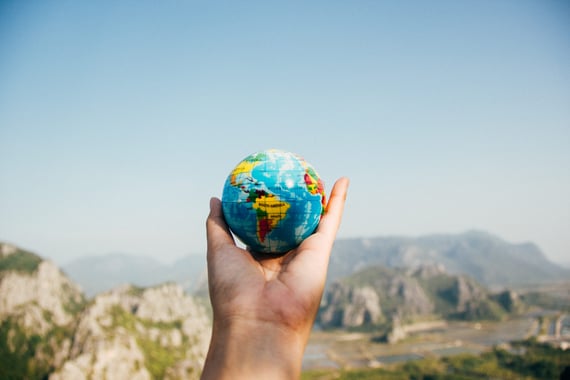 Hand holding a miniature globe