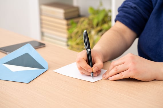 A man writing in a farewell card