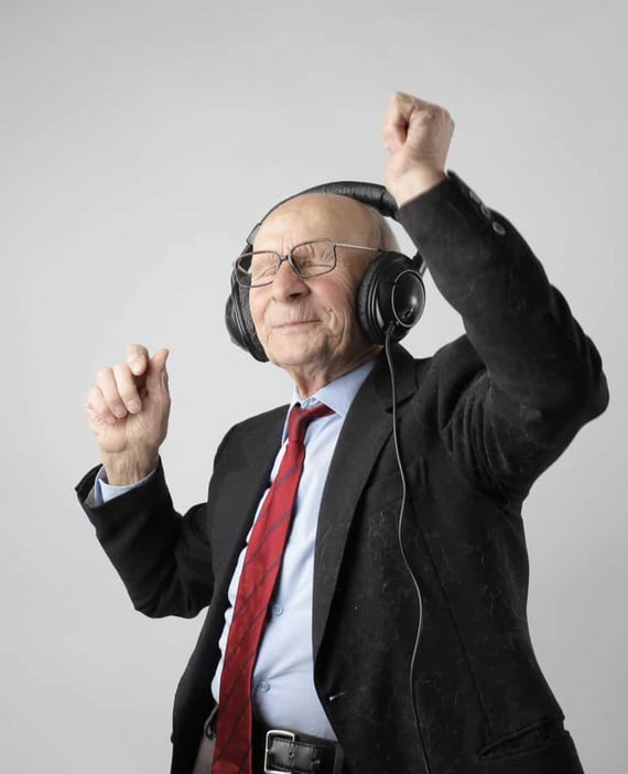 Older man dancing to music in headphones