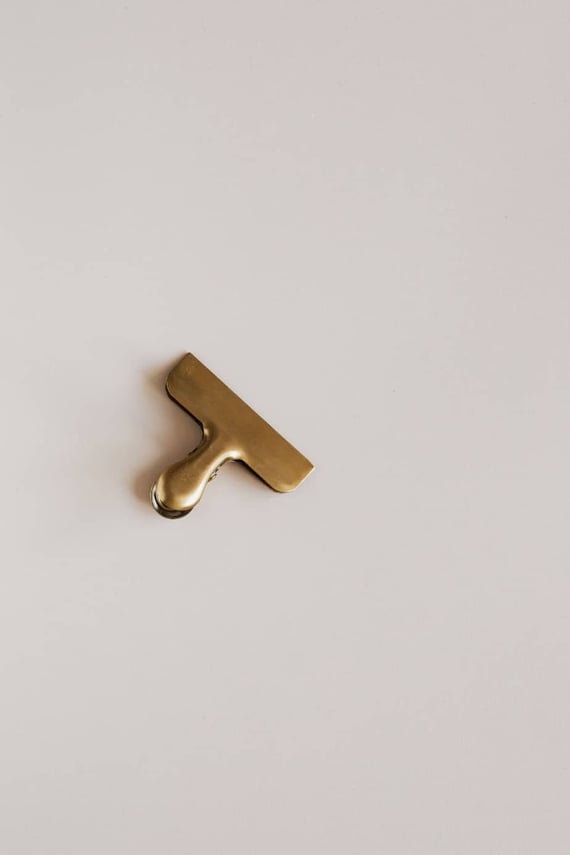 Gold clip sitting on white counter