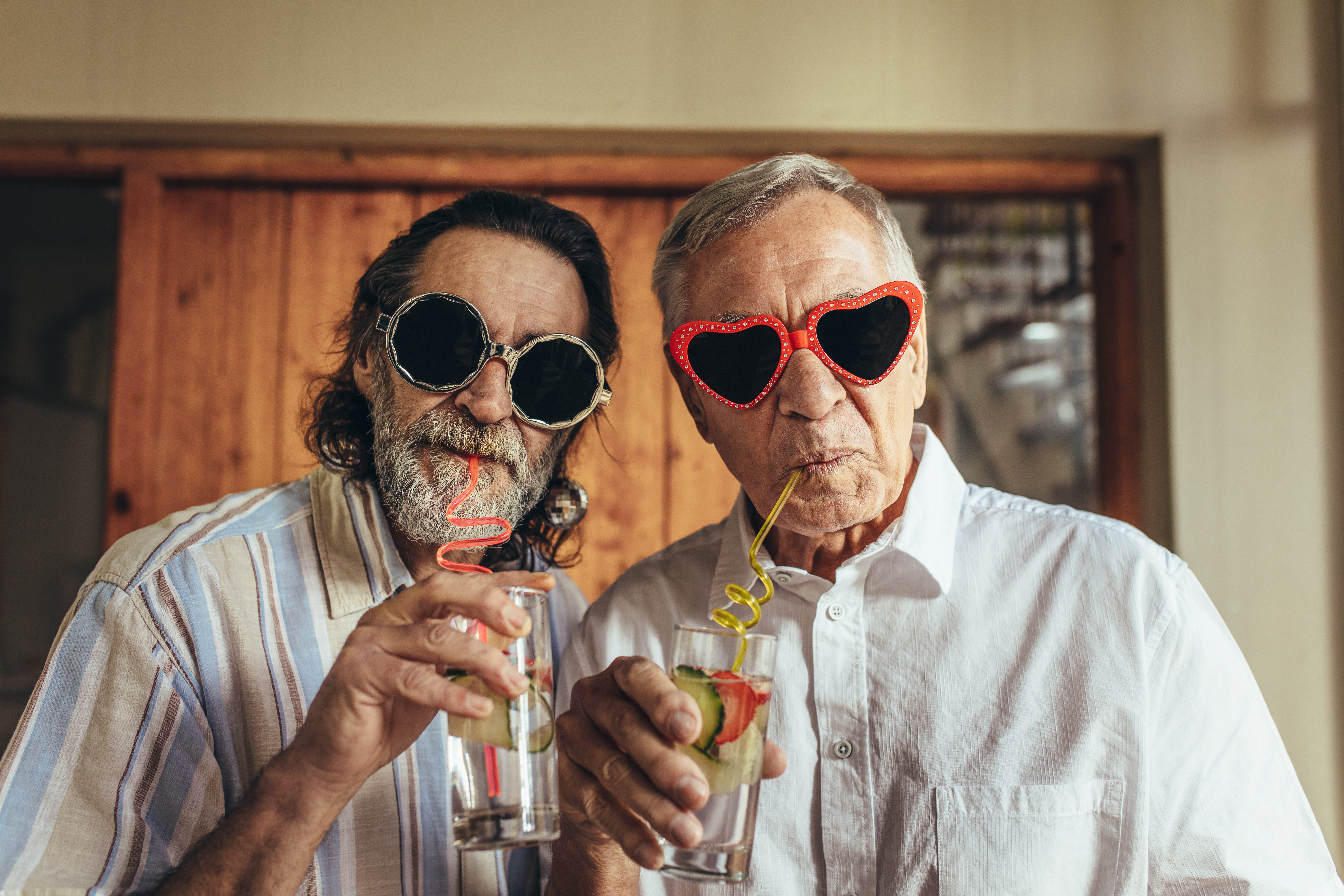 Two retired men wearing funny sunglasses