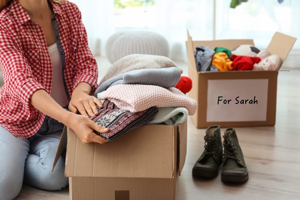 Person packing up old clothing