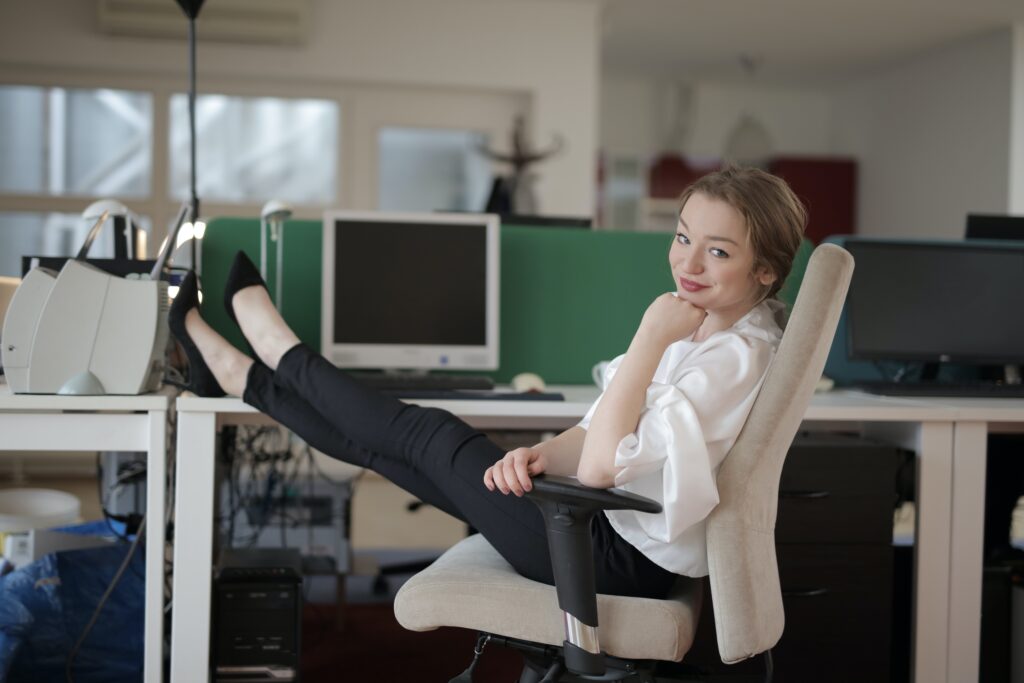 Woman sitting at desk and smiling at camera