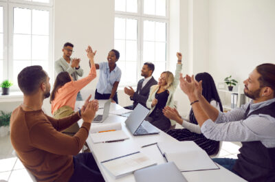 People celebrating employee in office