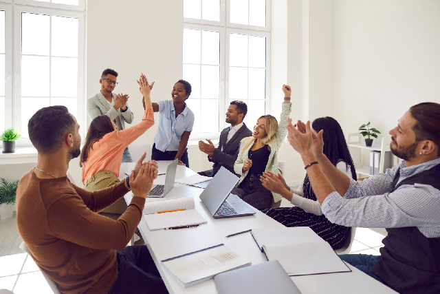 People celebrating employee in office