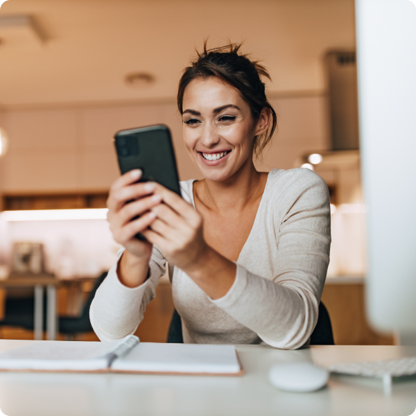 Woman smiling and looking at community notification on phone