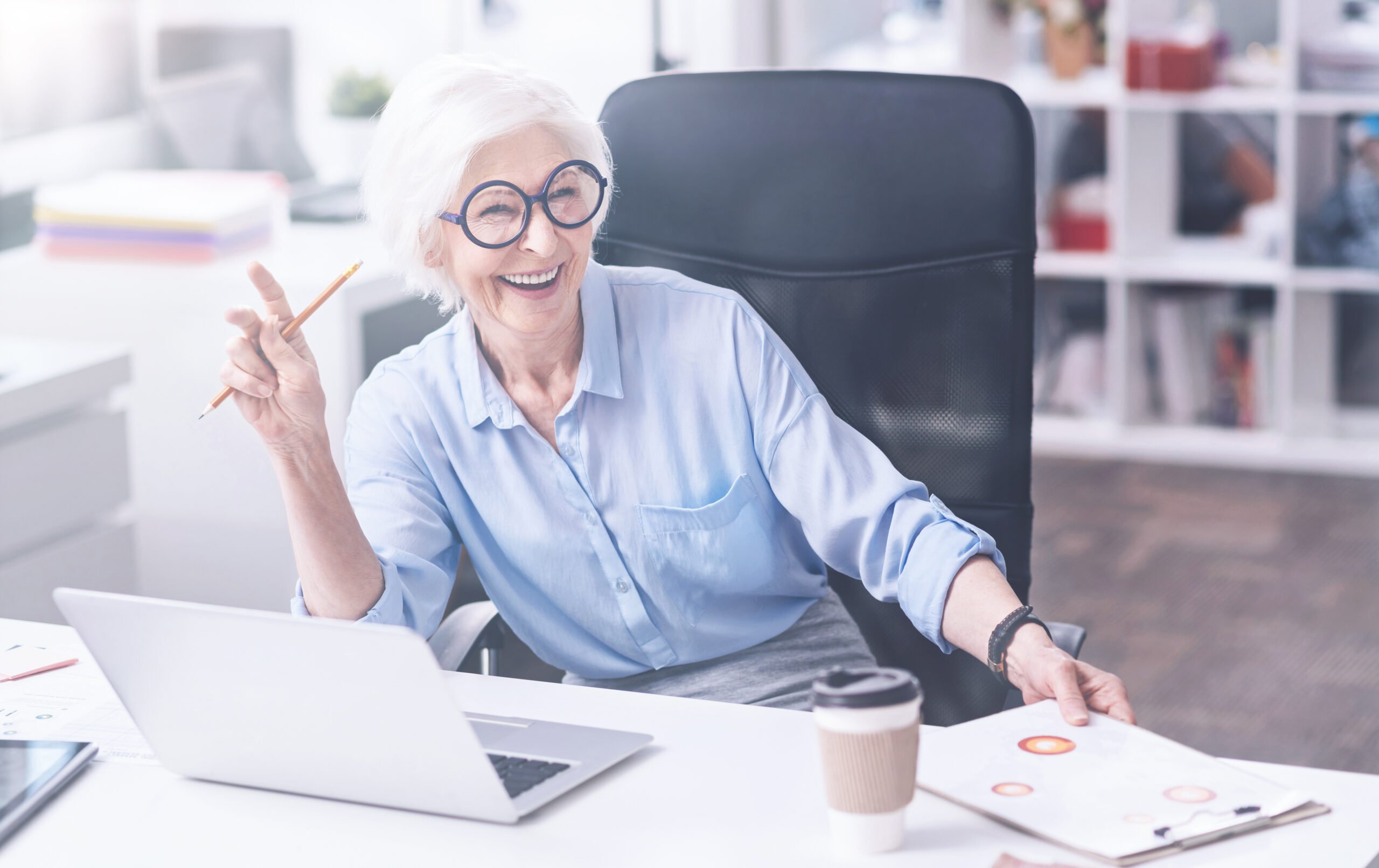 Older woman sitting at a desk with computer