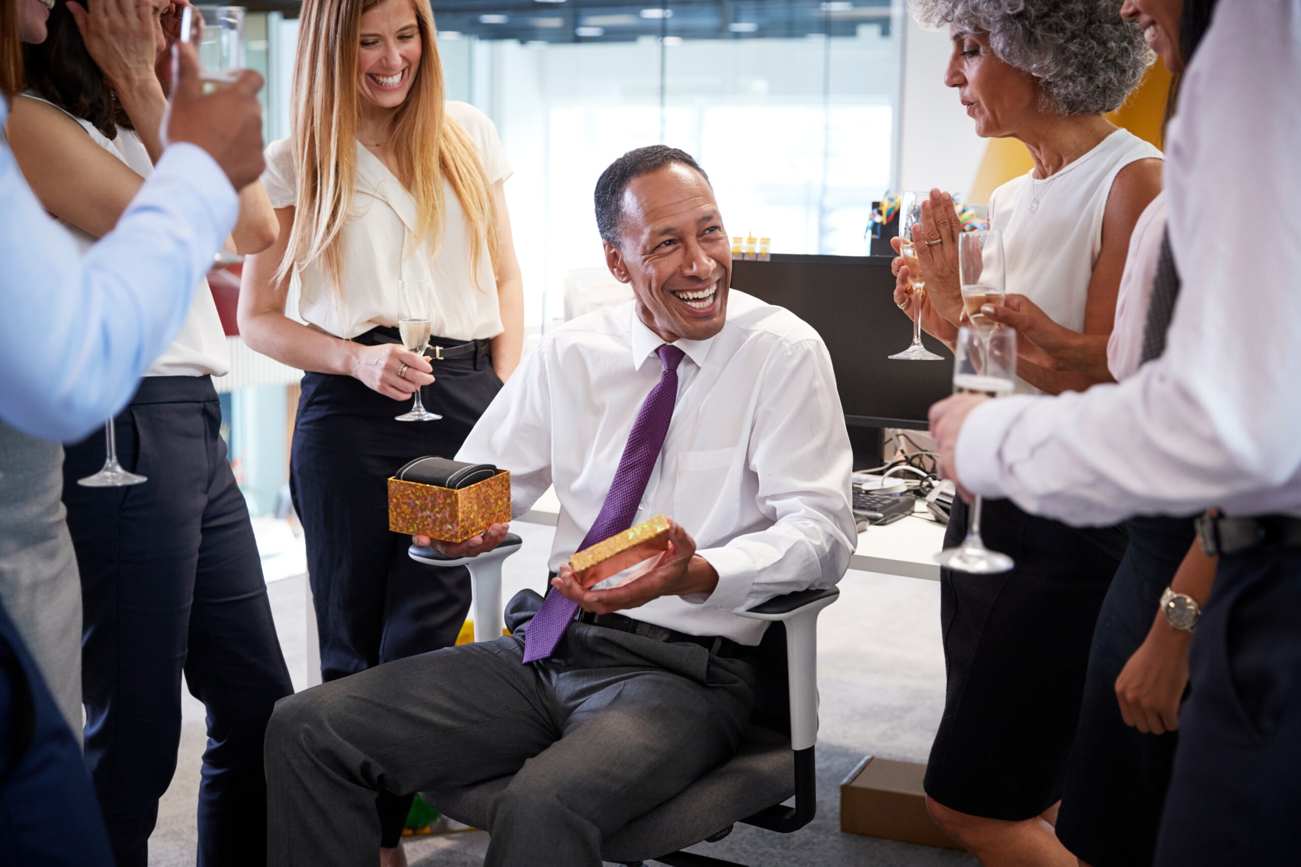 Man being given a retirement gift by employees