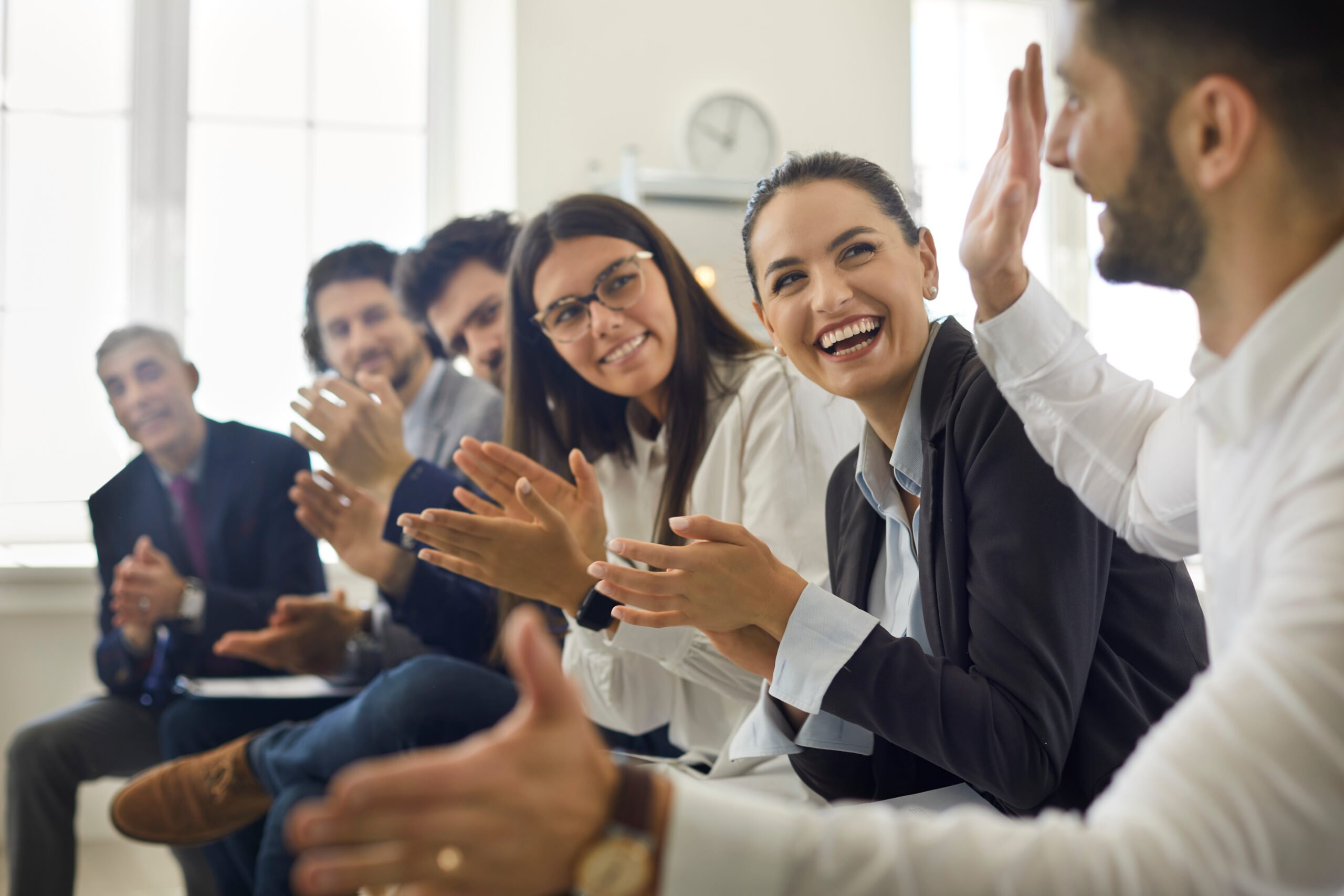 Employee receiving messages from larger team in office