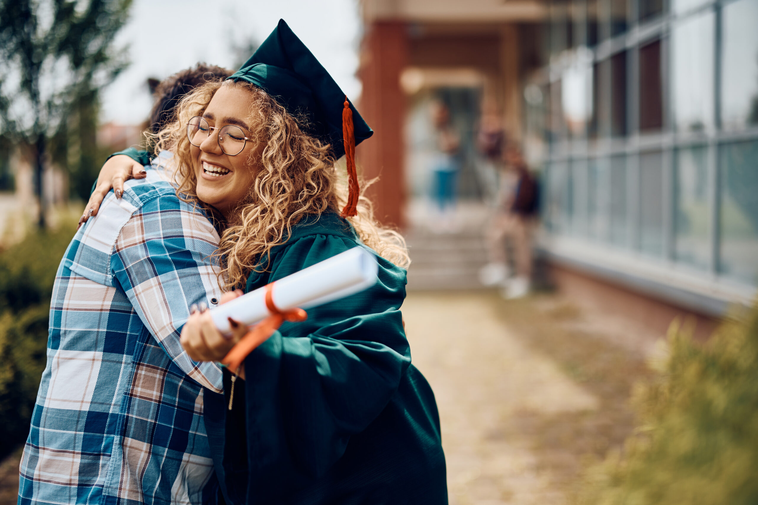 Parent hugging graduate after sending graduation eCard