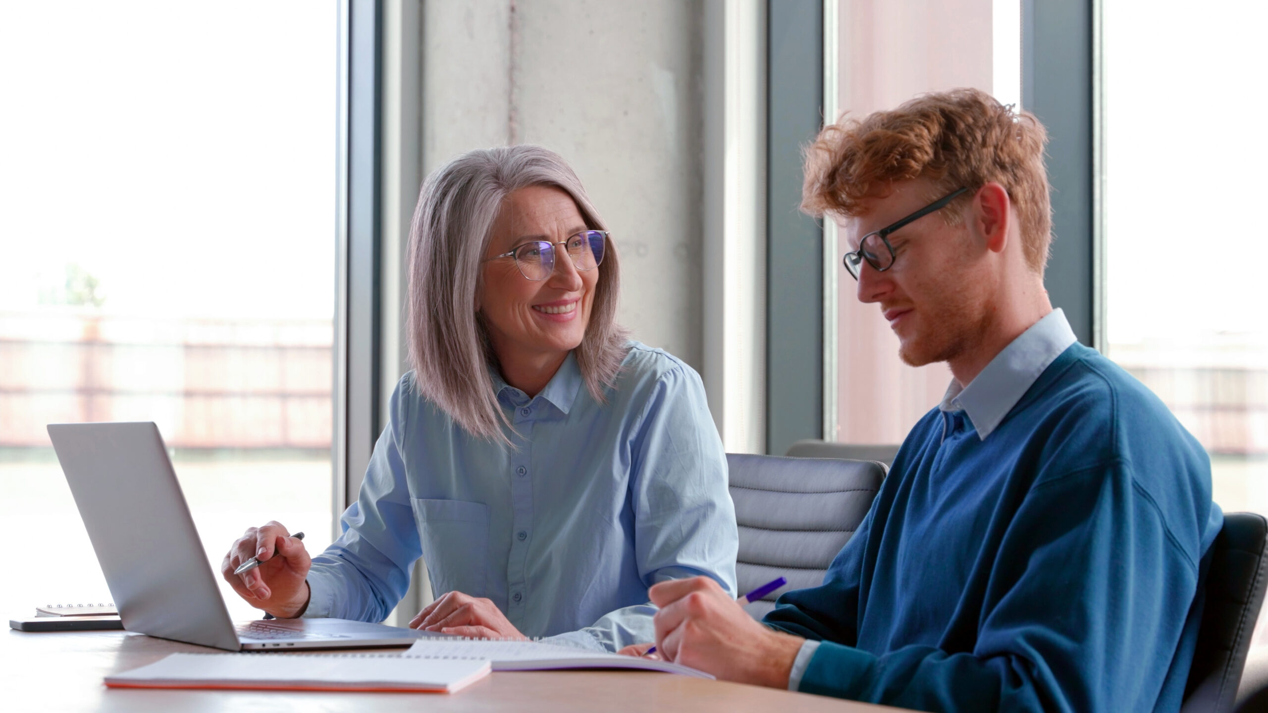 Older person working together with a younger person