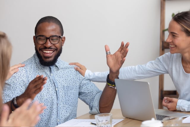 Smiling employee surprised by employee recognition messages