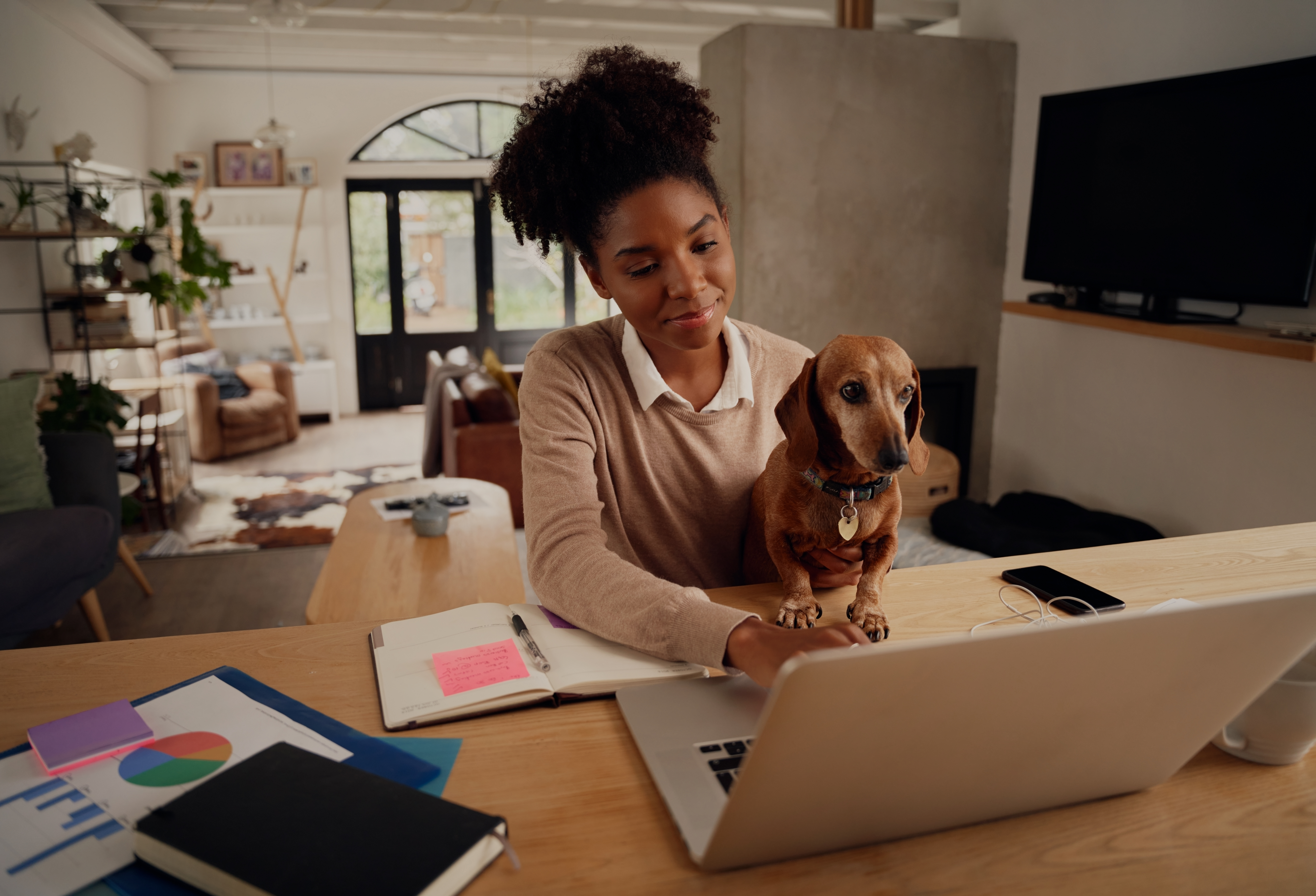 Employee with dog in front of laptop