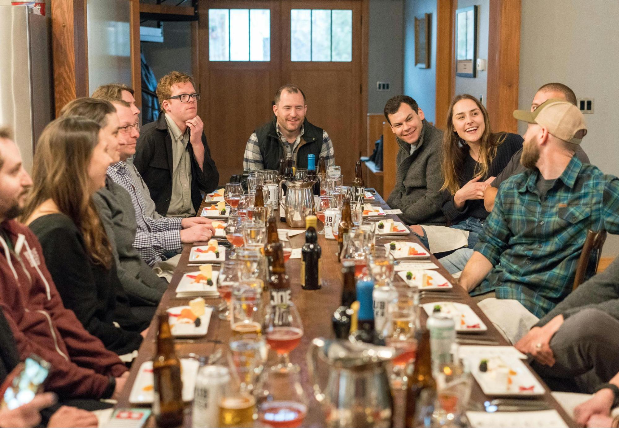 Employees sitting around a dinner table and chatting