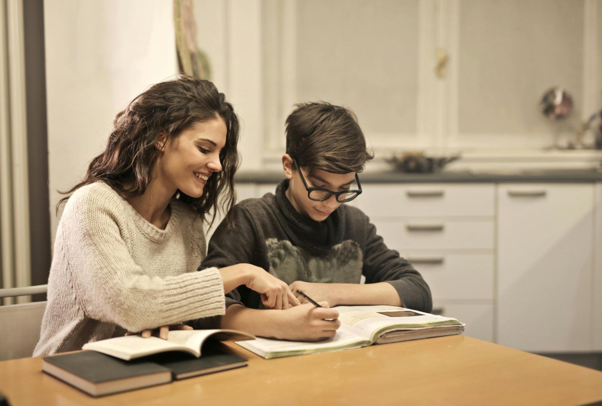 Teacher working with a student at table