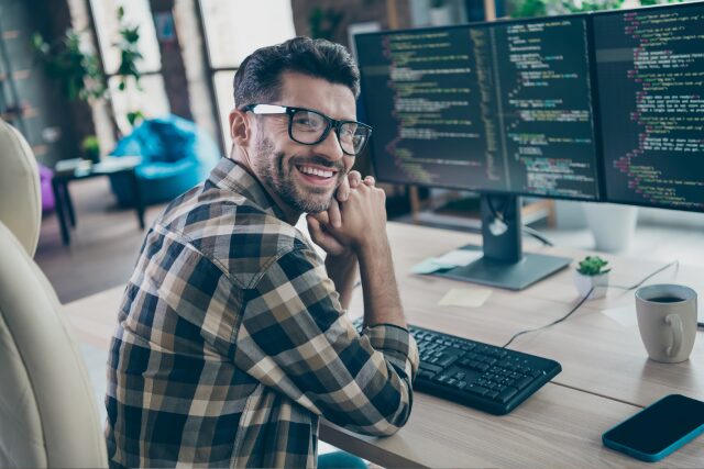 System admin sitting at desk on SysAdmin Day