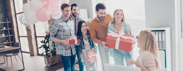 A group presenting a group gift to a coworker