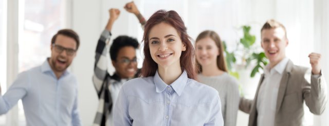 A team celebrating a woman at work