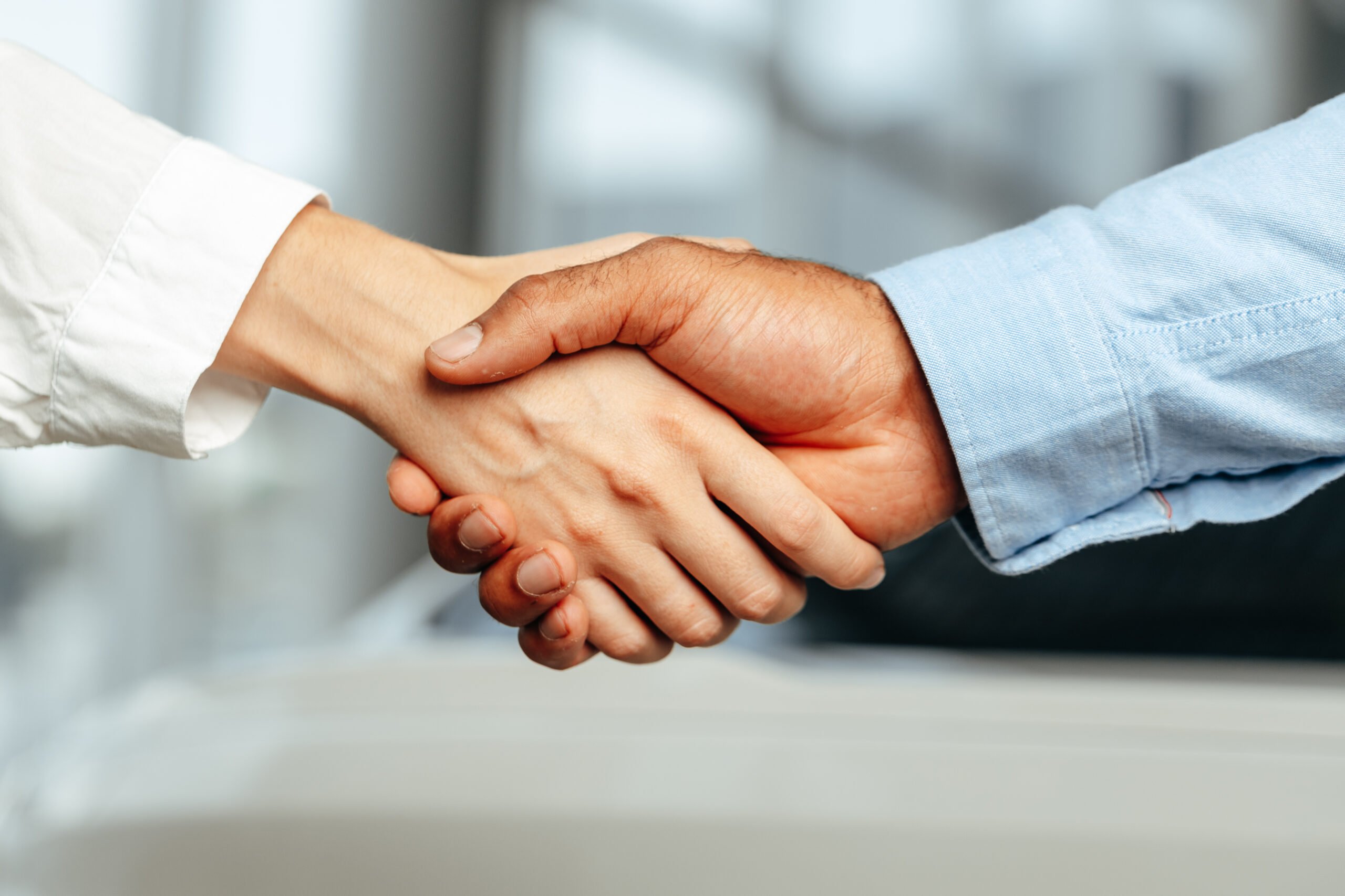 Female and male businesspeople handshake close up photo